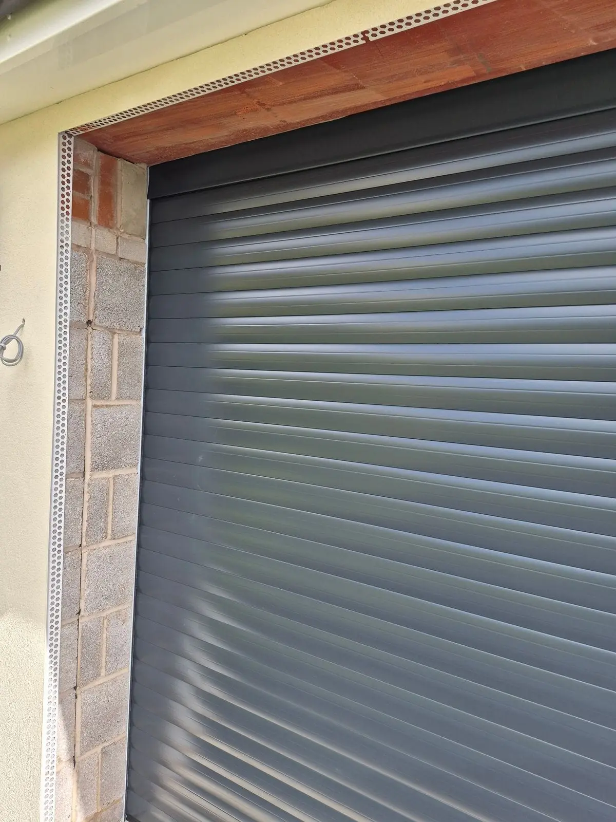 New anthracite roller shutter fitted in a brick opening