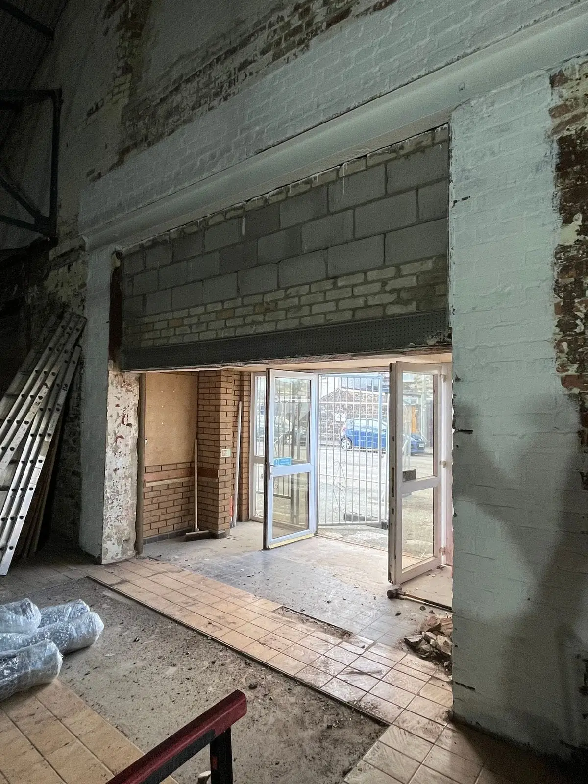 Brick opening prepared for a new roller shutter with building works in progress
